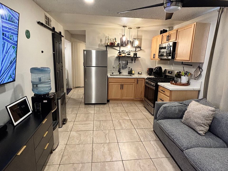 Kitchen/ living room combo. A/C window unit. Ceiling fan. All appliances included. Deep farm style kitchen sink with dish drying rack. Furniture not included.