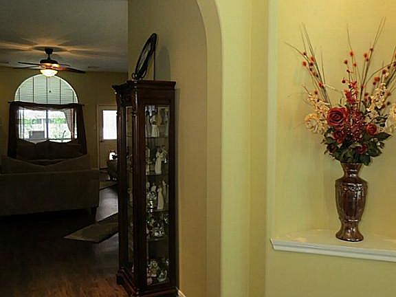 Foyer features elegant arches, lighted art niche