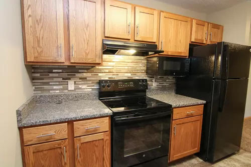 Our newly updated apartments include granite and backsplash in the kitchen. - The Northbrook Apartments