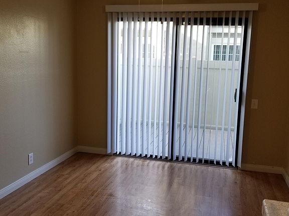 Dining room area with ceiling fan with sliding door access