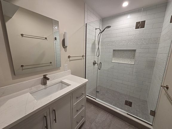 Bathroom with walk-in shower and large vanity