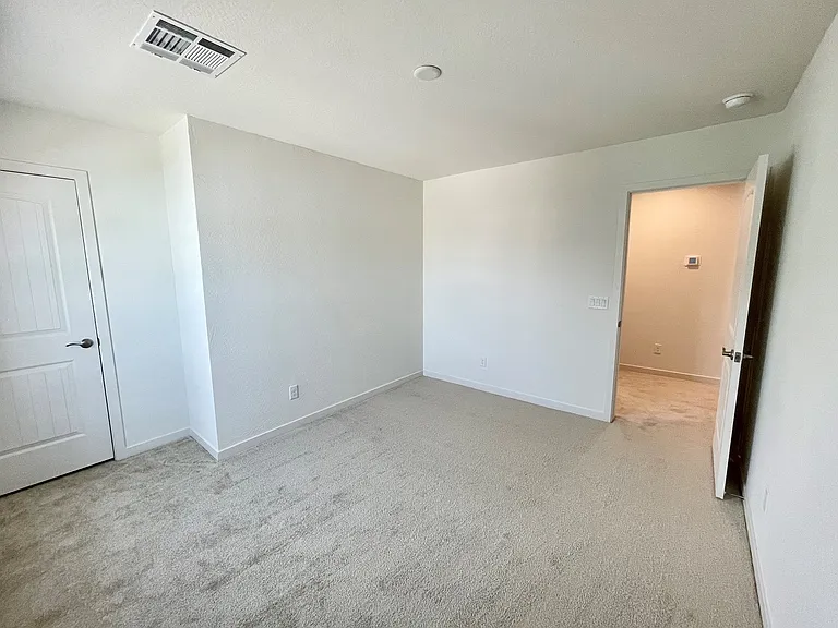 Bedroom 2 with walk in closet on left and door to hall.