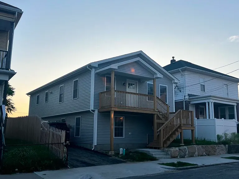 Exterior photo. Off street parking to left of house. Unit is entire upstairs
