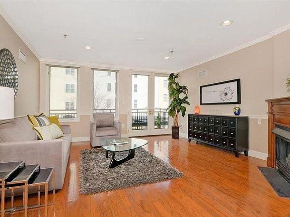 Living room with fireplace and balcony