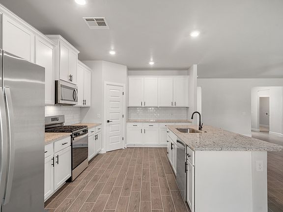 The kitchen has energy-efficient, stainless-steel appliances.