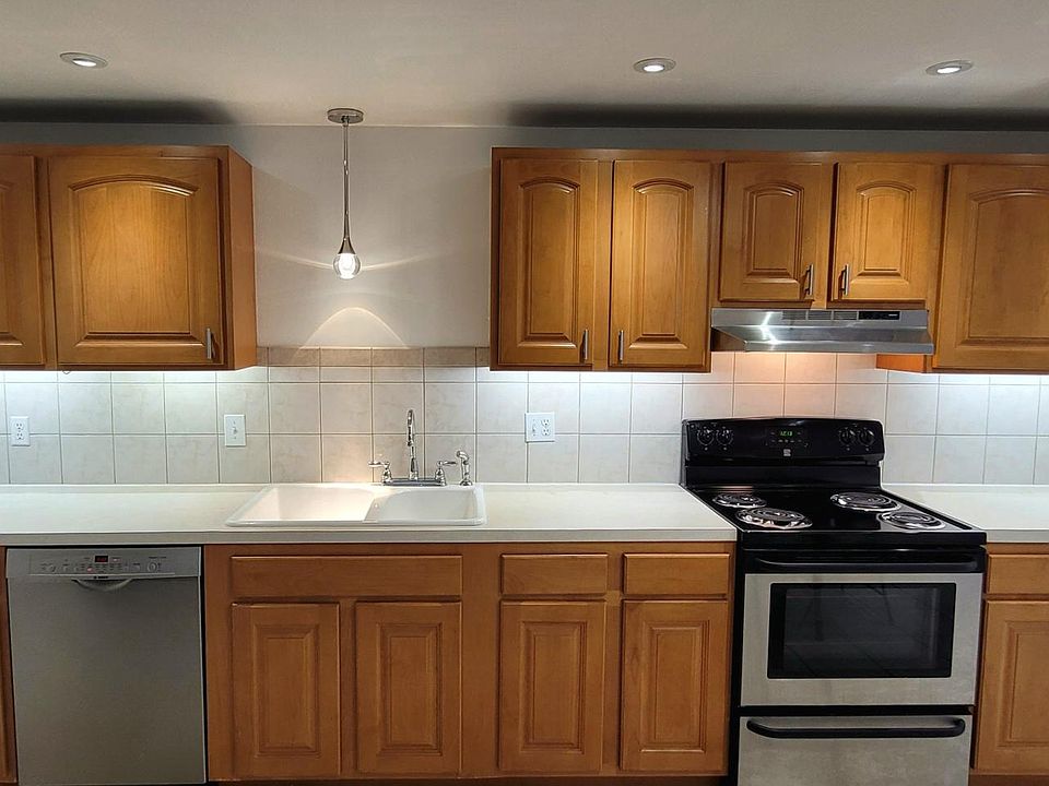 Modern kitchen with under cabinet lighting and LED accent lighting. All stainless appliances. Bosch dishwasher, Frigidaire refrigerator and. Kenmore electric stove