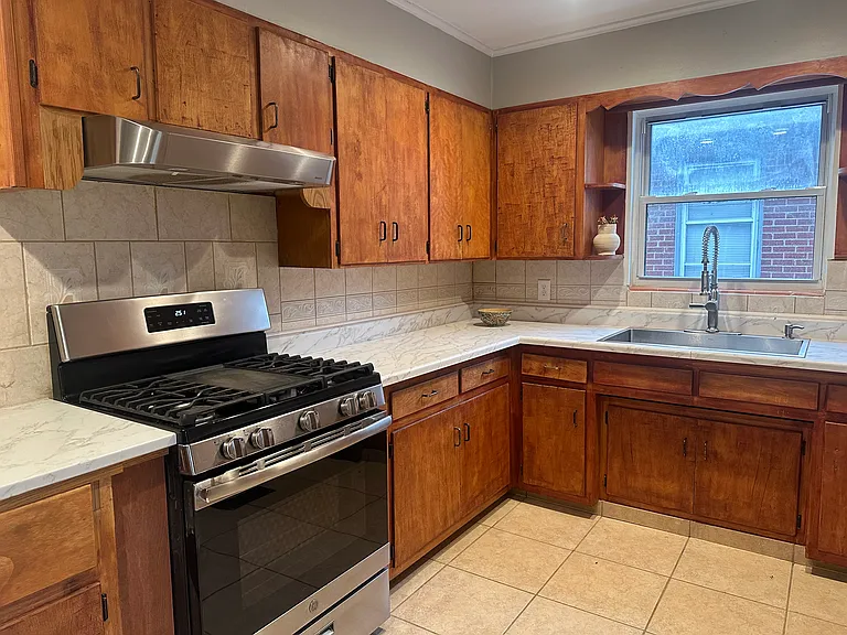 Kitchen with 2 year old stove, new hood vent, new stainless steel sink