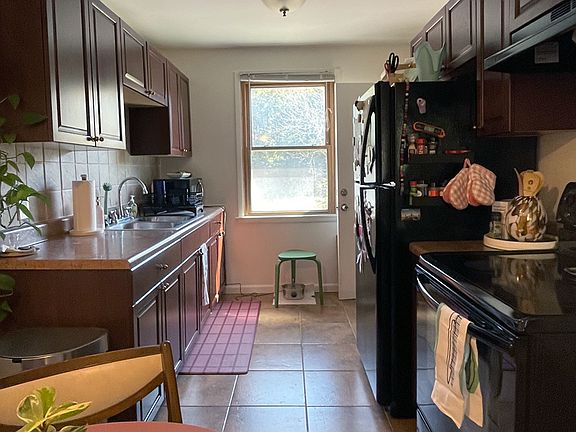 Eat-in kitchen with full-size refrigerator and pantry.