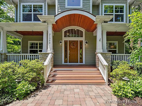 Custom copper roof and wooden headboard ceiling on welcoming front porch.