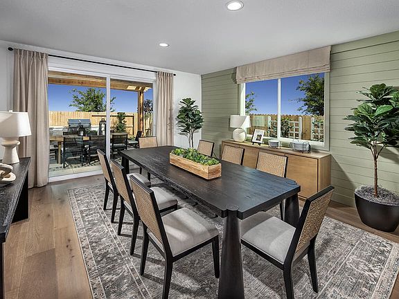 This open dining area is bright, spacious, and perfect for gathering. Large windows let in abundant
