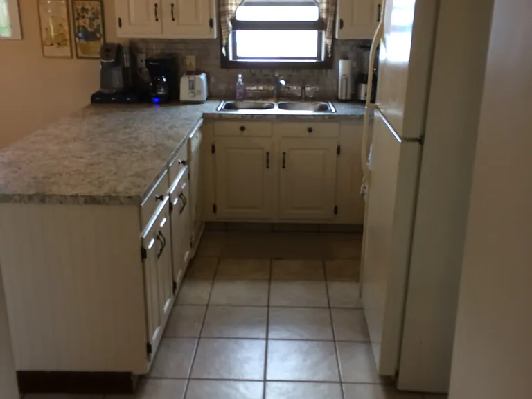 Fully stocked kitchen with dishwasher, refrigerator, and gas stove; coffee makers and toaster; microwave and blender