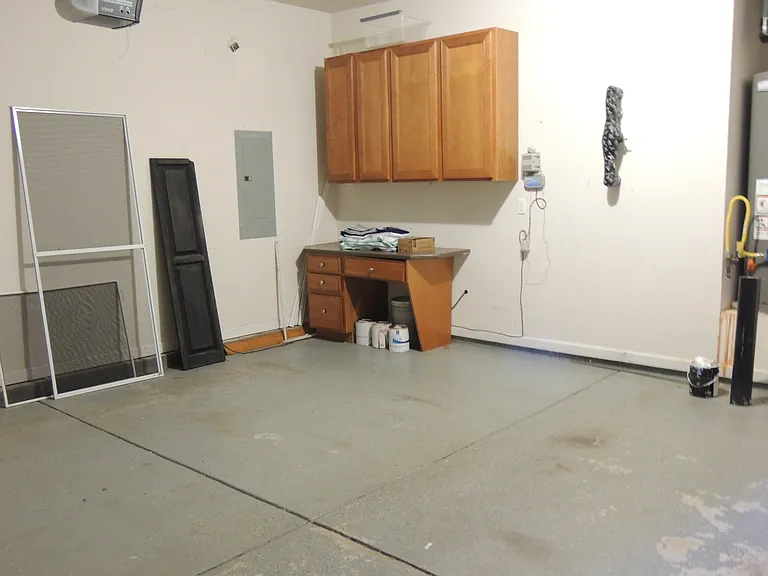 Garage with cabinets and desk
