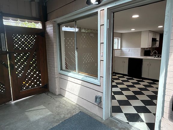 Front door and front gate to driveway from covered patio.