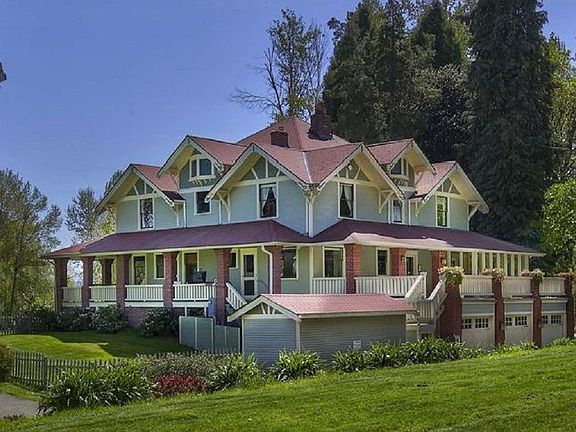 Fabulous 1300 sq ft covered porch surrounds this majestic home. Often been termed "The house of 14 gables." 3 car
attached garage, complete with terrace above, perfect for entertaining large groups.