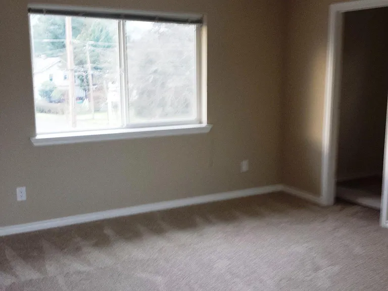 Bedroom 1, with new carpet and fresh paint.