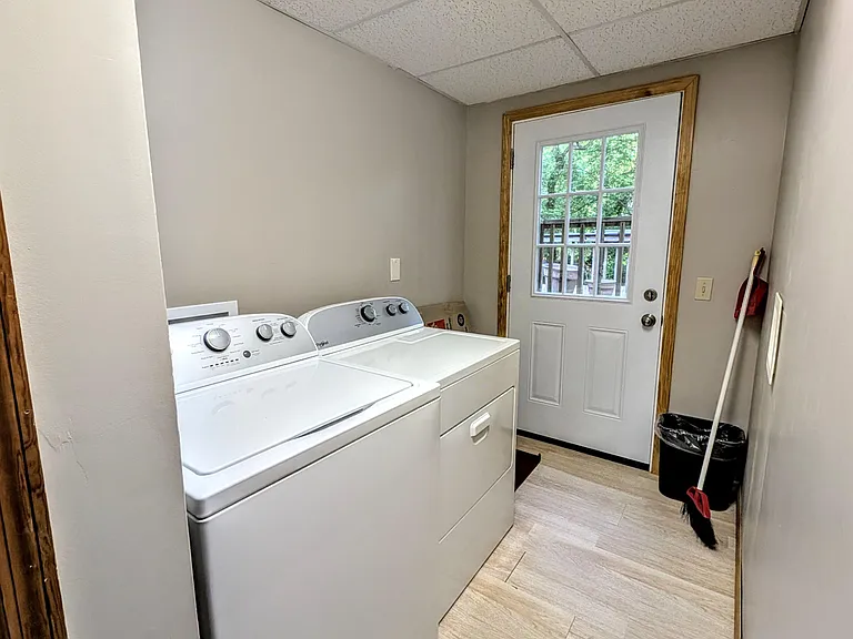 Dedicated laundry room with full-size washer and dryer and a private exterior door for easy access.