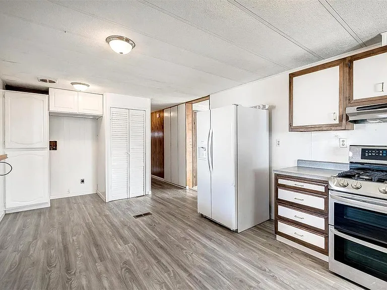 Large kitchen and dining room with new gas cooktop, 2 ovens, double sink, dishwasher, large refrigerator and freezer, and lots of cabinet space. Washer and Dryer moved to kitchen where tall cabinet is in photo. Tall cabinet moved next to other cabinets