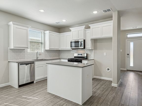 Kitchen in the Pearl home plan by Trophy Signature Homes - REPRESENTATIVE PHOTO