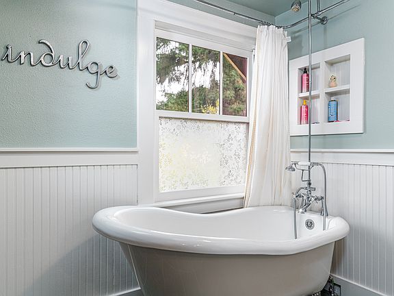 I designed this spacious bathroom, converting a bedroom to include a clawfoot tub and shower for your choice of relaxation. When the curtain is open, soaking in the tub feels like relaxing under the 100-year-old fir tree - please indulge and enjoy!