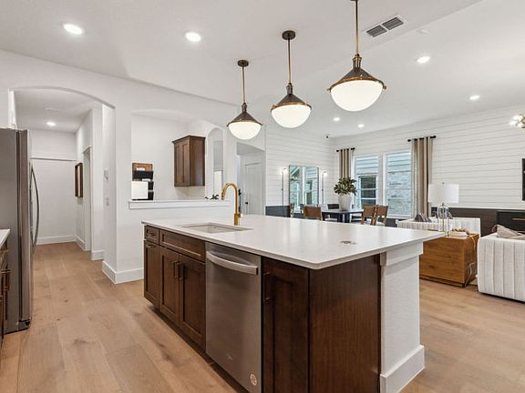 Large kitchen island with pendant lighting model representation