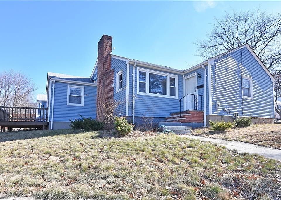 Exterior front: Corner lot, set higher above street.