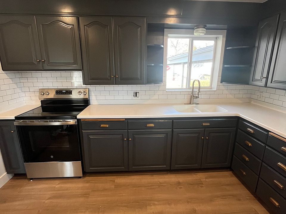 Kitchen with lots of cabinet space and brushed gold faucet and antique brass hardware