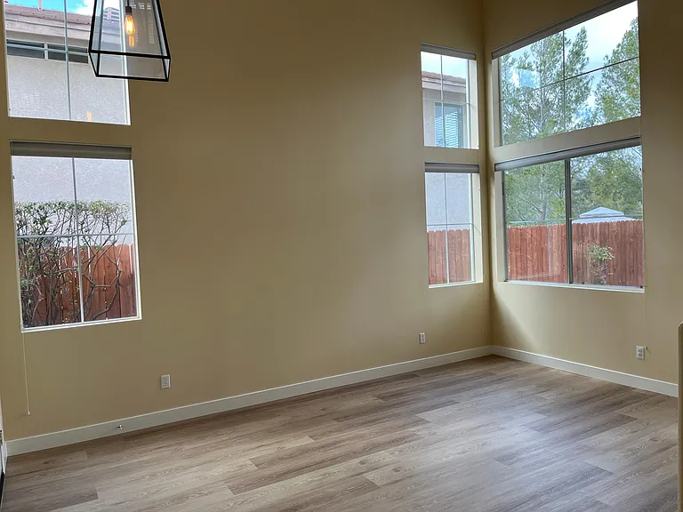 Bright living room with cathedral ceilings and plenty of light