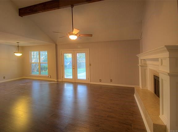 Large open living area.  Doors to the back yard and fireplace.