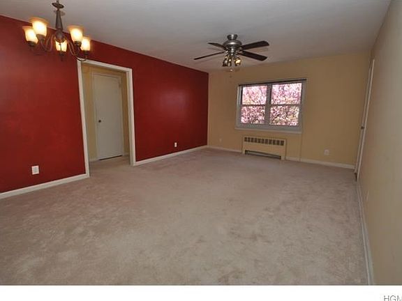 Bright large living room with wall to wall carpet and large walk-in closet.