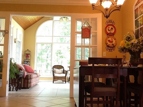 Sunroom/family room faces West
						:
						Ceiling to floor windows & door overlooking wooded yard or brick patio and pool