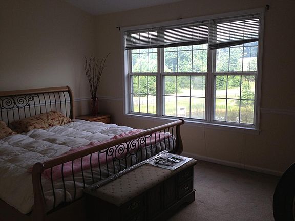 Bedroom overlooking water and trees