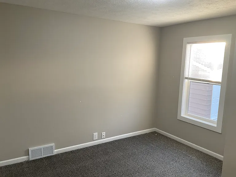 Bedroom 1 with NEW window, all new paint and flooring