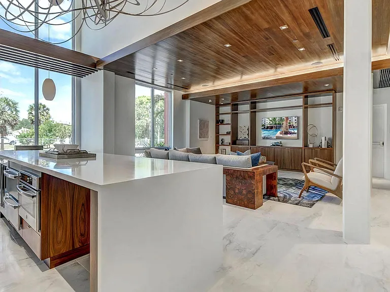 Resident Lounge with Large Windows, TV Area, and Kitchen Space