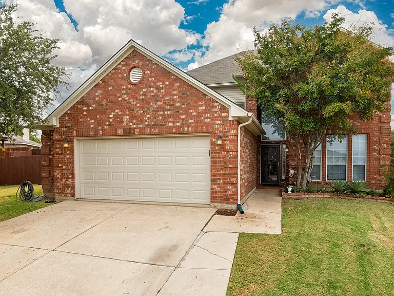 Welcoming brick home with a two-car driveway and front yard. Quiet neighborhood setting, private entrance, and easy parking for guests.