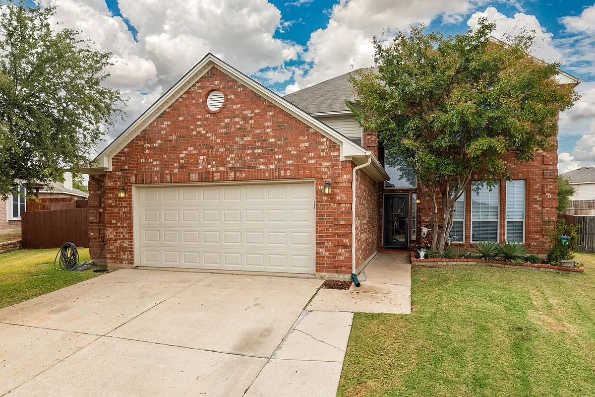 Welcoming brick home with a two-car driveway and front yard. Quiet neighborhood setting, private entrance, and easy parking for guests. - 8824 Fayetteville Dr