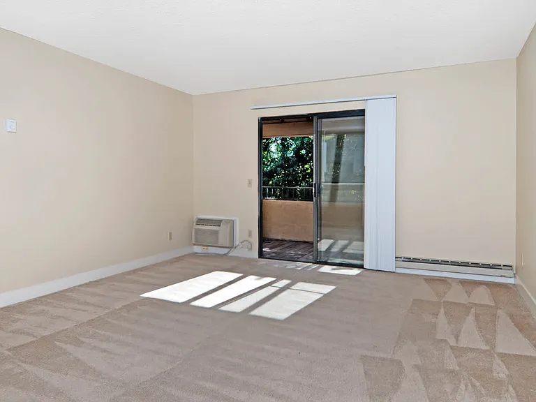 Carpeted Living Room with Balcony