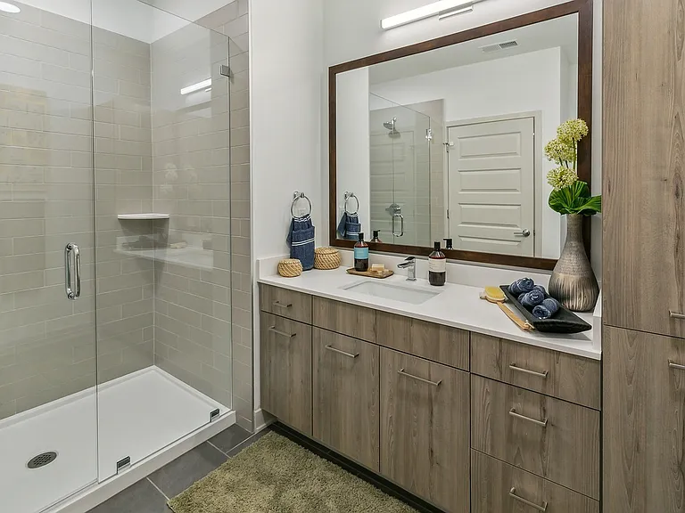 Refresh in style with sleek finishes, a spacious vanity, and a walk-in glass shower.