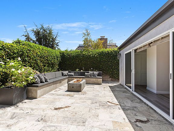 Private & sunny courtyard with gas fire pit and built in seating