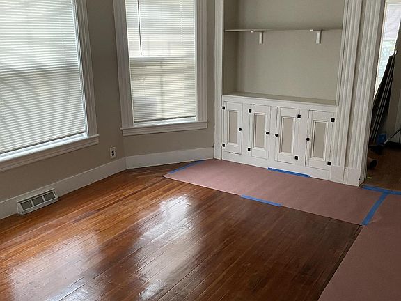 Other side of living room Custom built in cabinet with storage Ceiling fan/ light