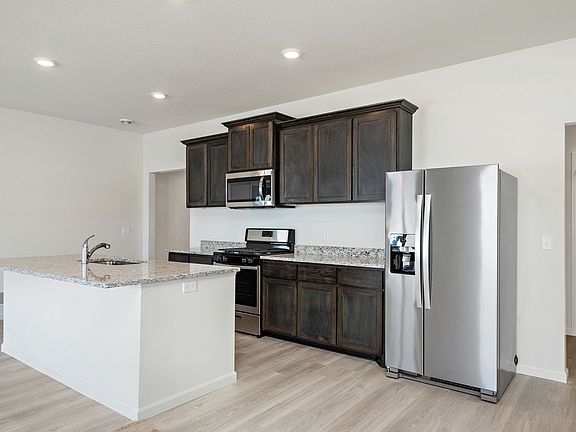 The kitchen is chef-ready with stainless steel appliances