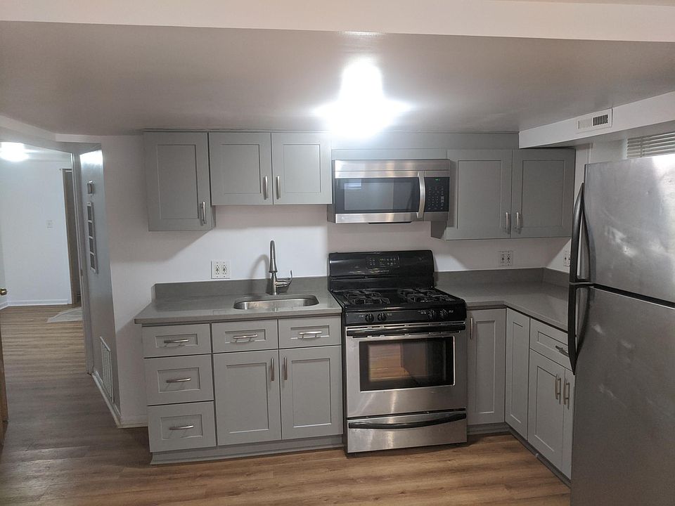 Newly remodeled kitchen, quartz countertops. View into back bedroom.