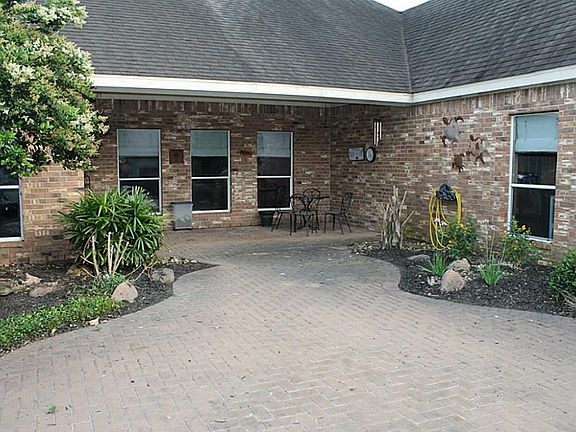 Back porch is covered with extra concrete patio