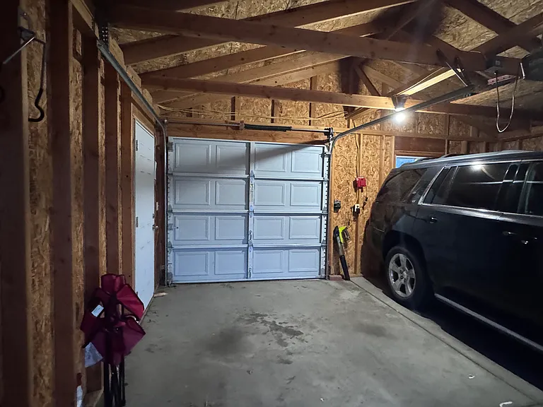 Pass-through garage doors allow for access to back yard through alley.