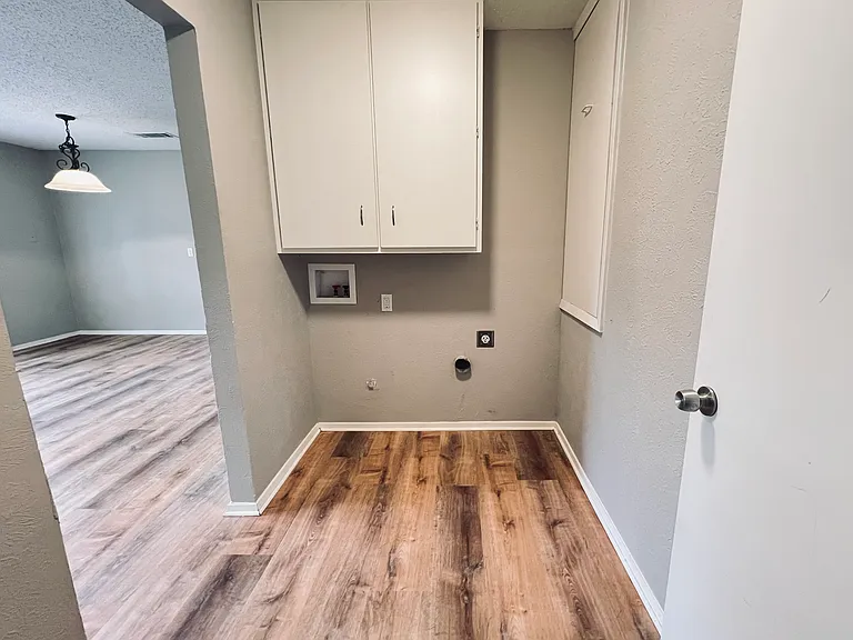 Utility room with full size washer and dryer connections. Nice tall large cabinets above the washer for storage. For washer location: height under cabinet 48", depth of cabinet 12"