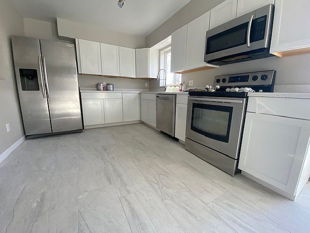 Newly remodeled kitchen with new floors, countertops, cabinets, sink, lights, etc.