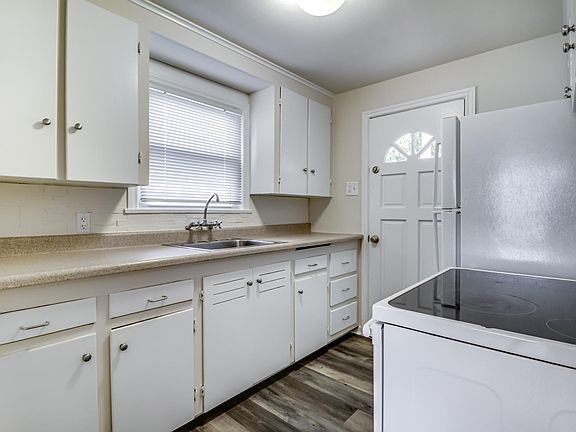 Kitchen with smooth top stove and door to back deck