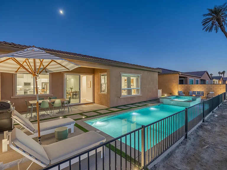 The home is beautifully illuminated in the evening.