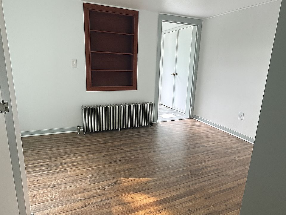 Bedroom. View: Standing in the kitchen, closet to the left, and bathroom and second exit at other doorway.