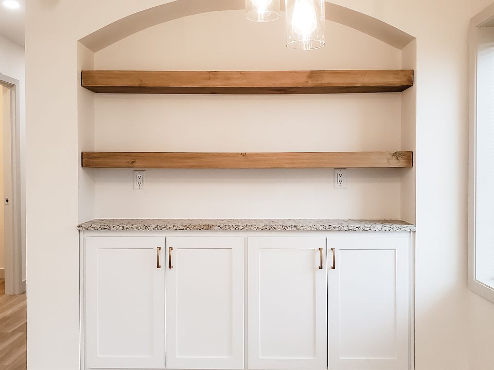 Built in cabinets and shelves and a window in the dining area