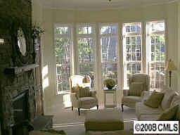 Beautiful stone fireplace with large rounded bay window.